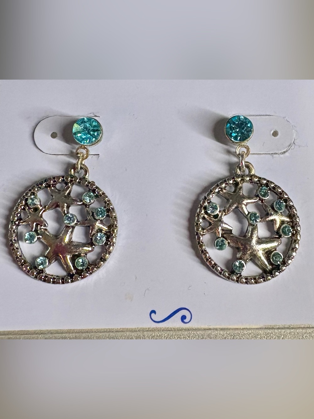 Post earrings: turquoise glass in silver toned emblem with starfish.